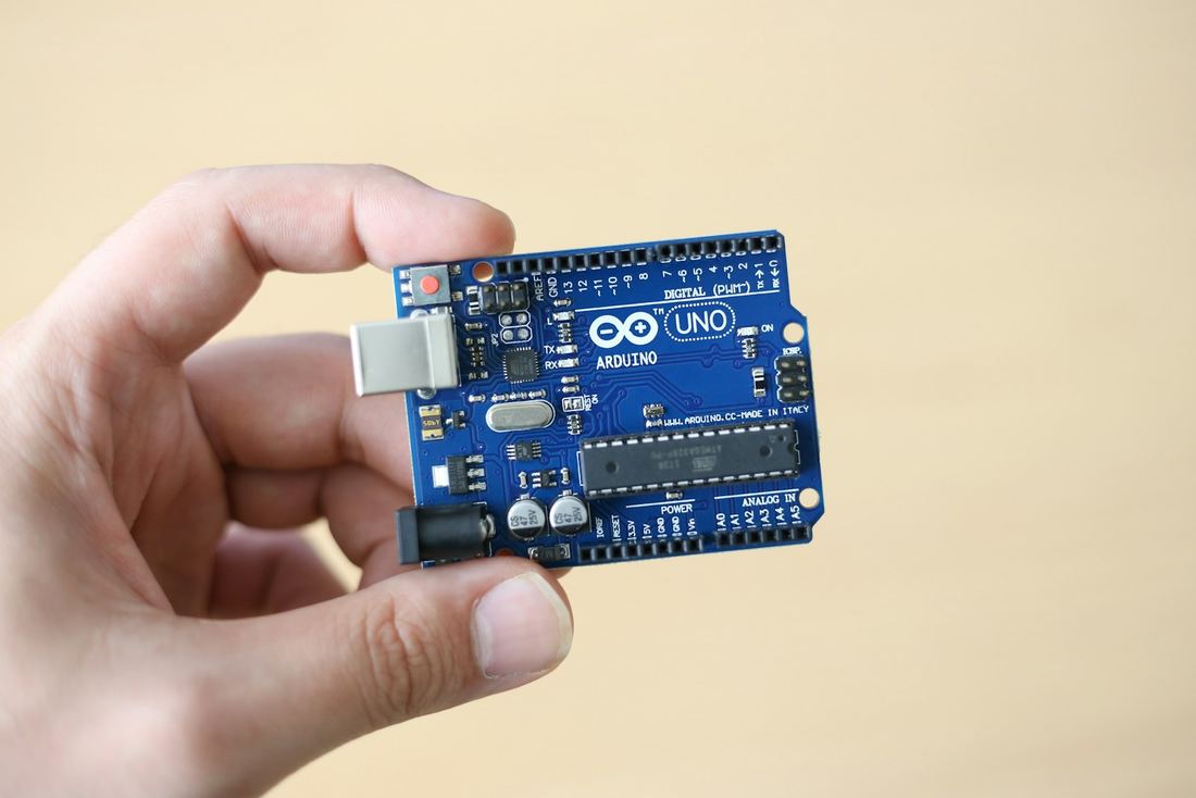 Arduino board held in the hand