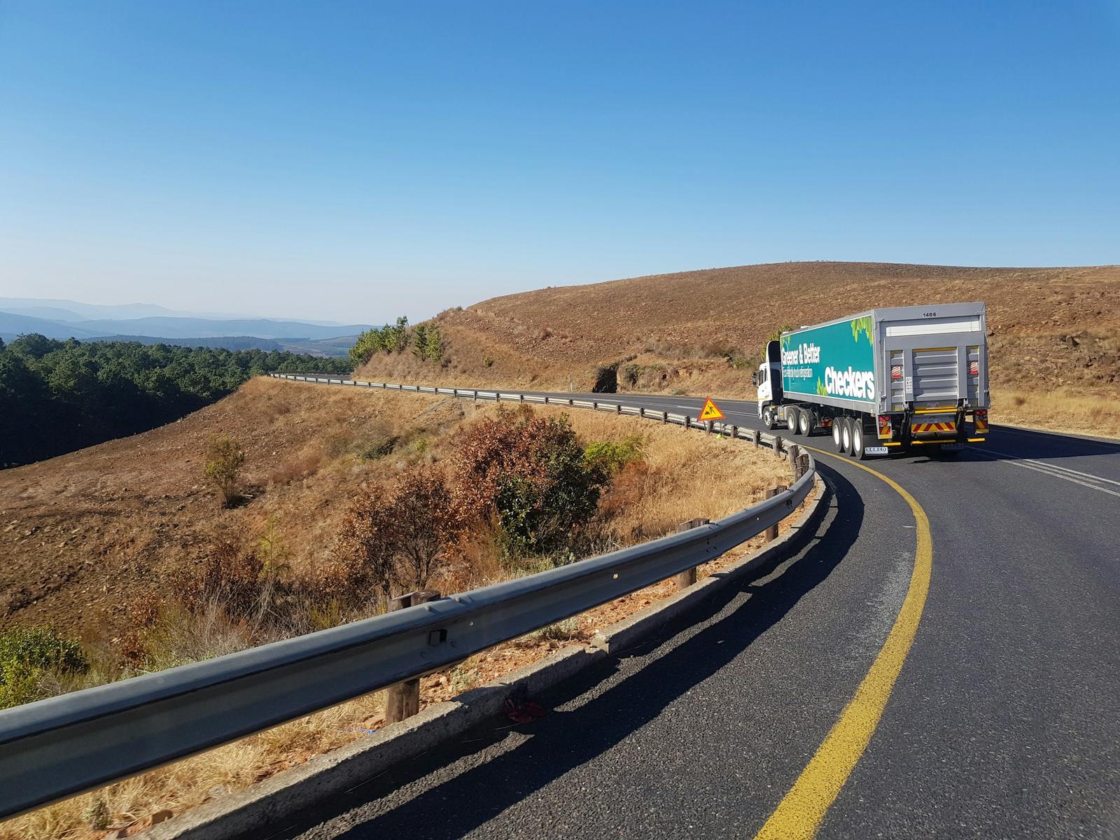 Truck on a winding highway between hills