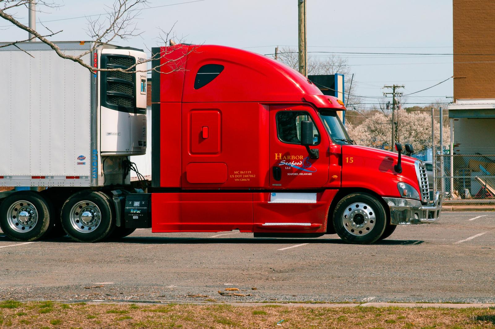 Truck with a refrigerated trailer parked in a yard